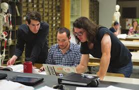 three men looking at laptop screen