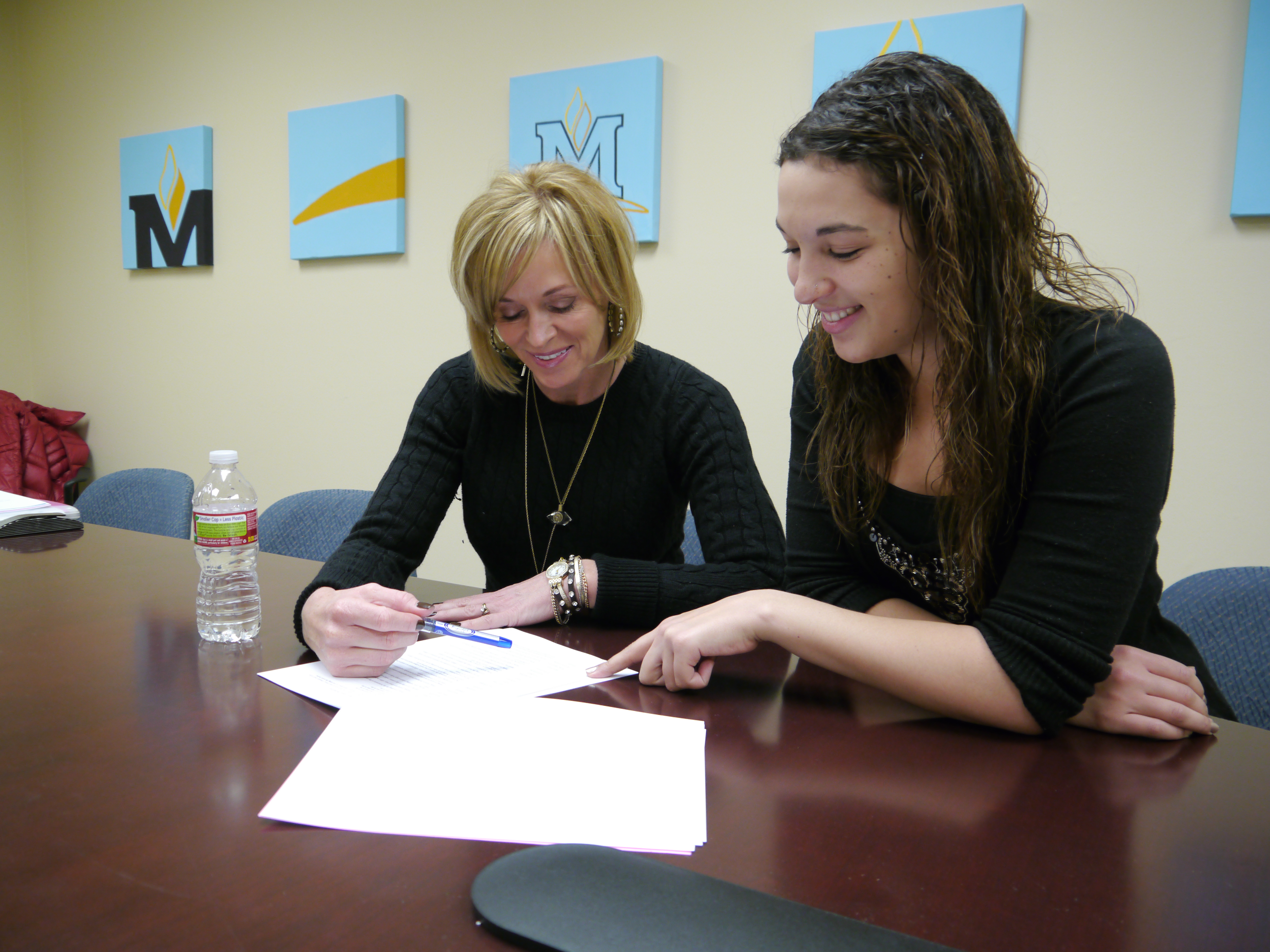 A picture of an Academic Adviser and a student finding scholastic success