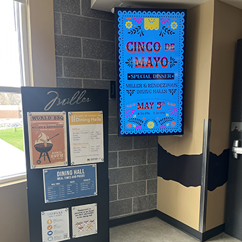 tv screen at the entrance to miller dining commons