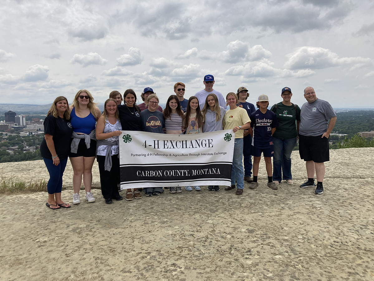 Group holding 4-H exchange sign