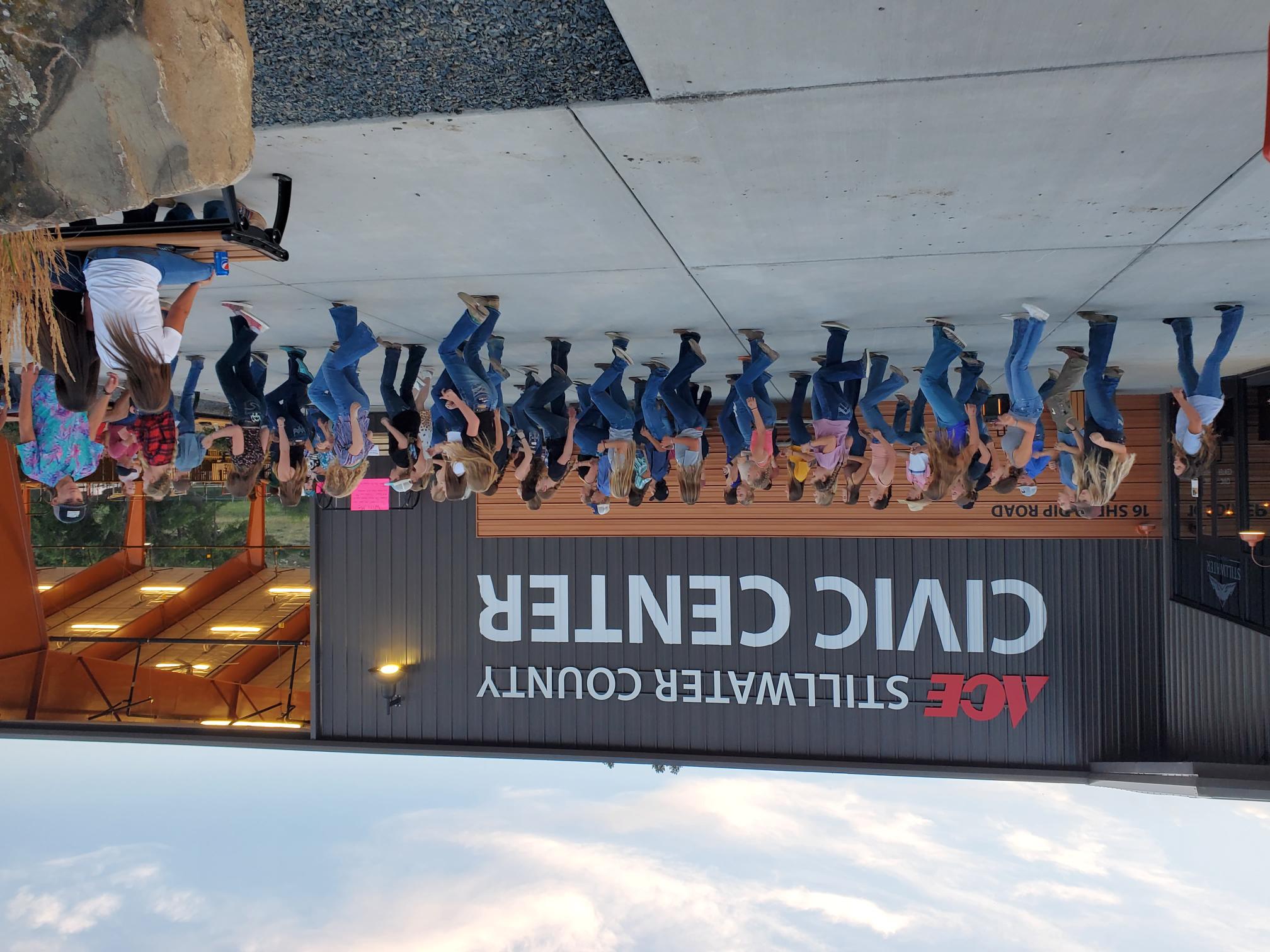 Outside patio of a new civic center featuring 4-H youth dancing