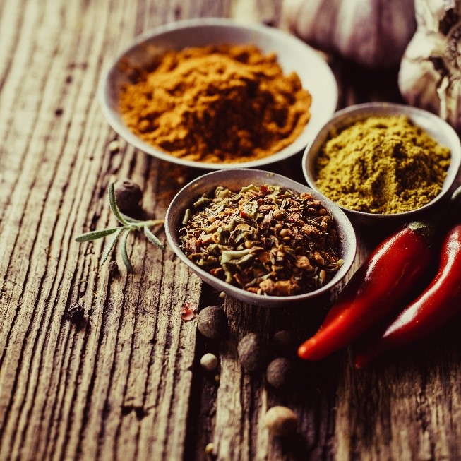 Three small dishes containing various seasonings. 