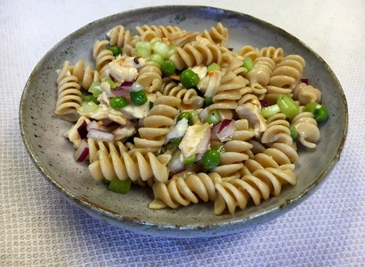 An image of pasta chicken salad in a gray bowl.