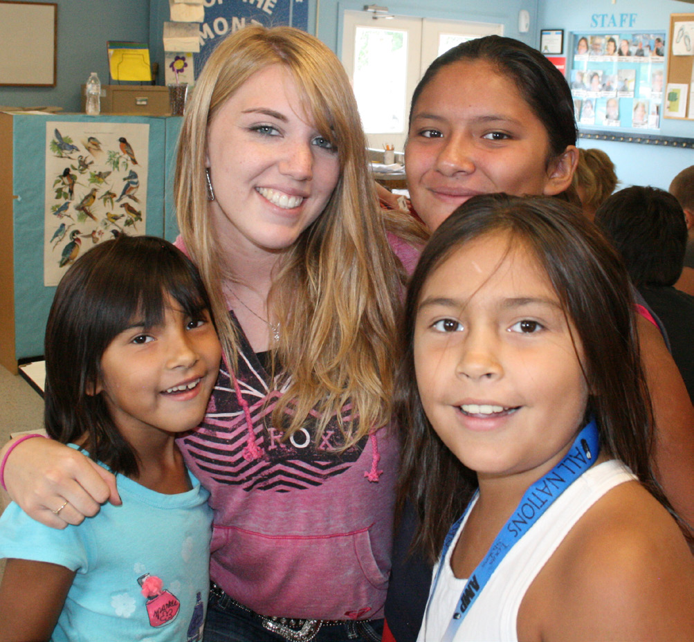 4-H members smiling at a meeting.