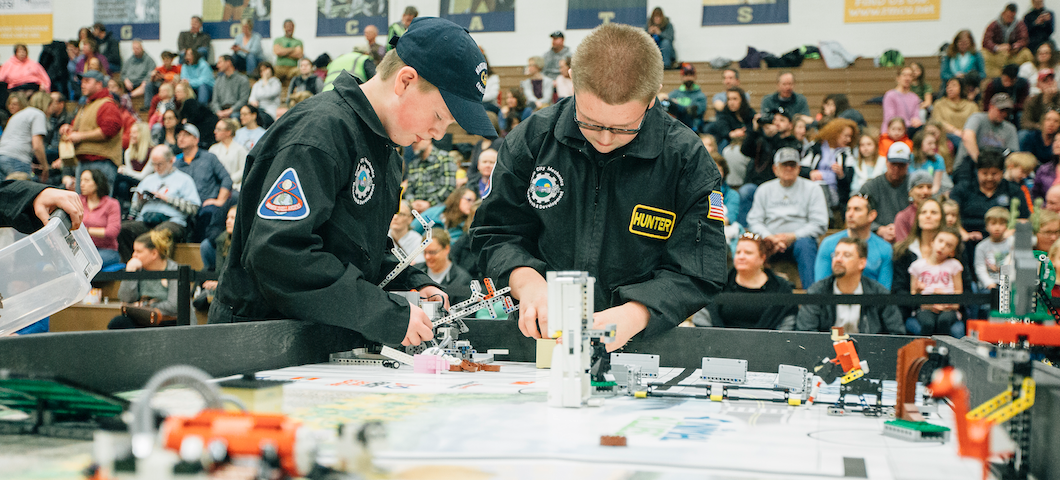 crowd of visitors in bleachers behind FIRST lego participants