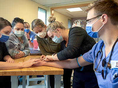 students looking at arm