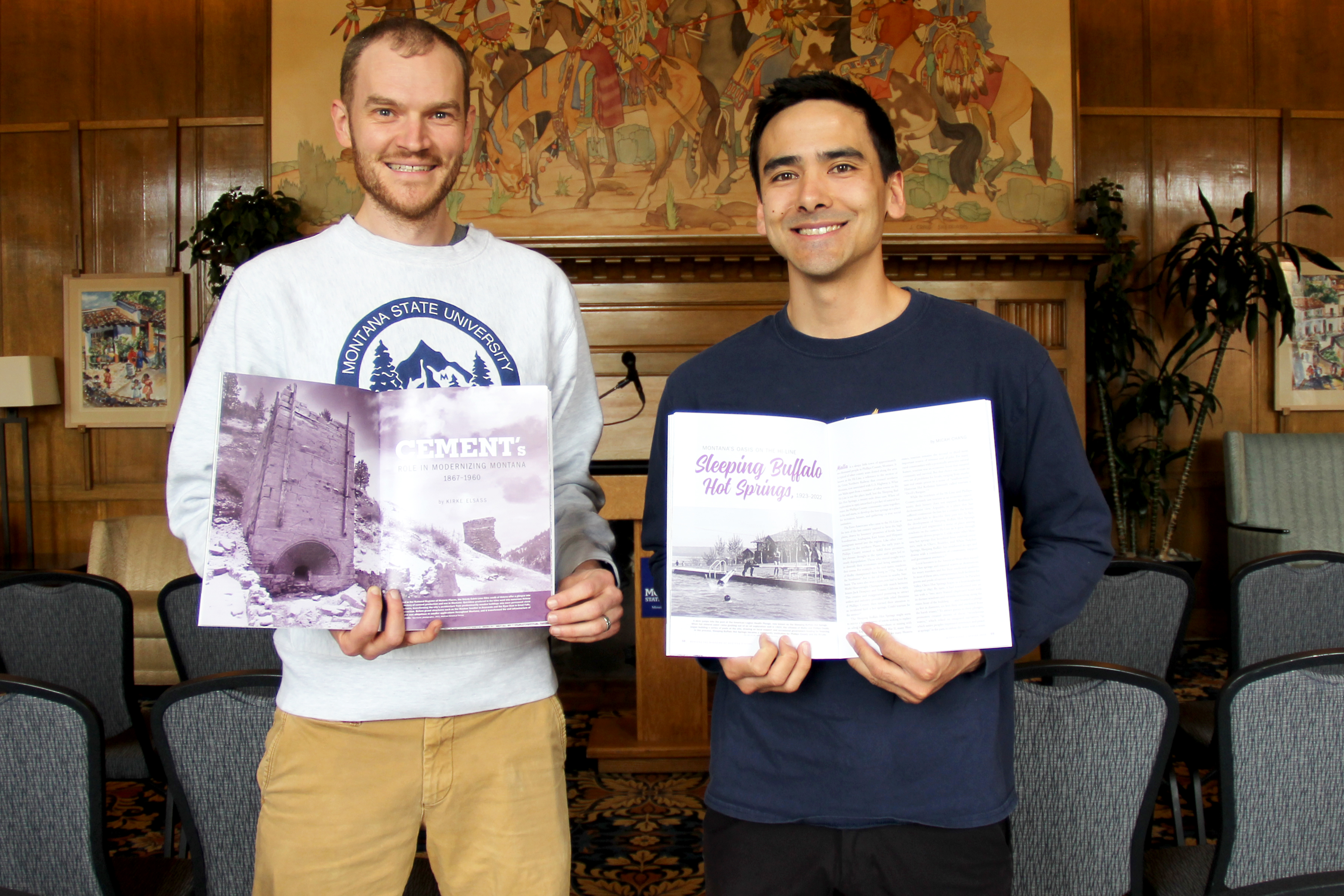 two men holding books