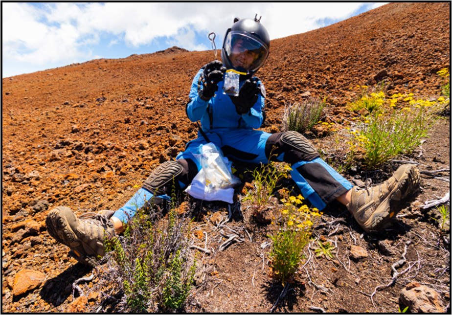 person in helmet sitting on ground