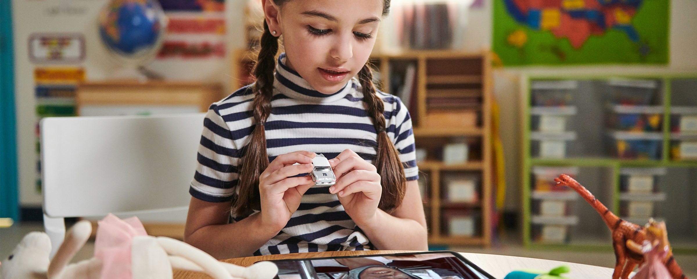 Girl holding matchbox car