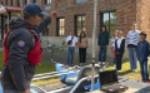 MSU Faculty member Eric Sproles speaks to middle- and high-school students about remote sensing on a small watercraft.
