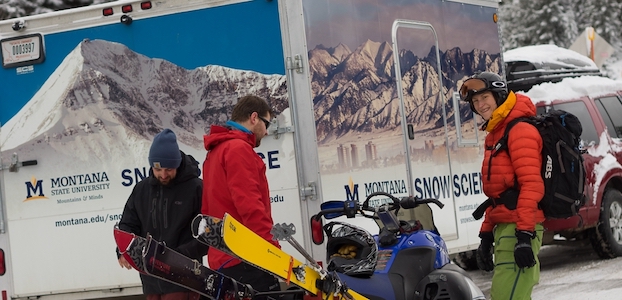 Hendrikx and research collaborators prepare equipment and snowmobiles in front of the MSU Snow Science trailer