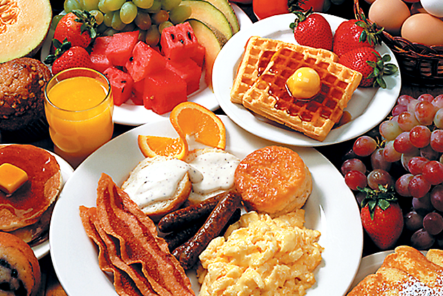 Assortment of Breakfast foods, coffeee, and juice, on a desk in the TRiO Offices