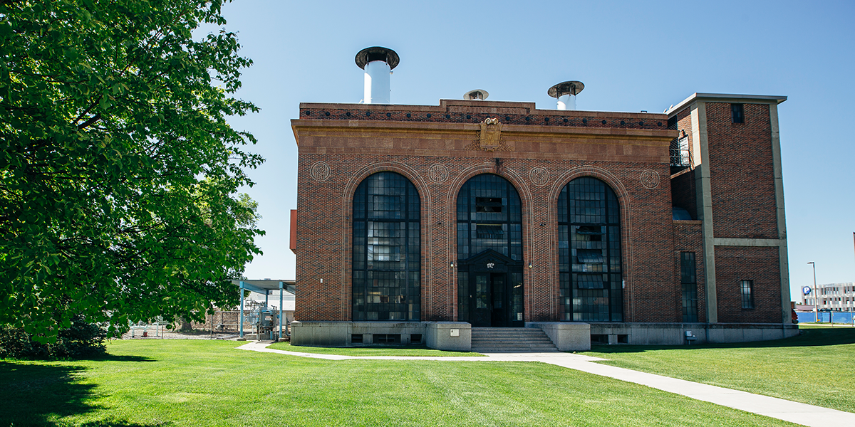 The outside of a brick building with three big arched windows